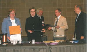 From left, Barbara Bailey, Jan Nocek, Peter Chase, and George Christian receive the Robert Downs Award in 2006 from then-ALA President Michael Gorman (center). Photo: George M. Eberhart