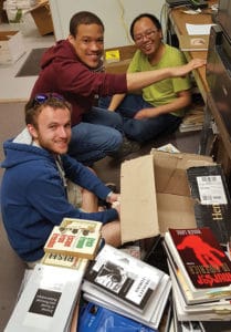 Virginia Tech graduate students sort through books donated to the Mzuni Library Initiative. Photo: Ralph Hall