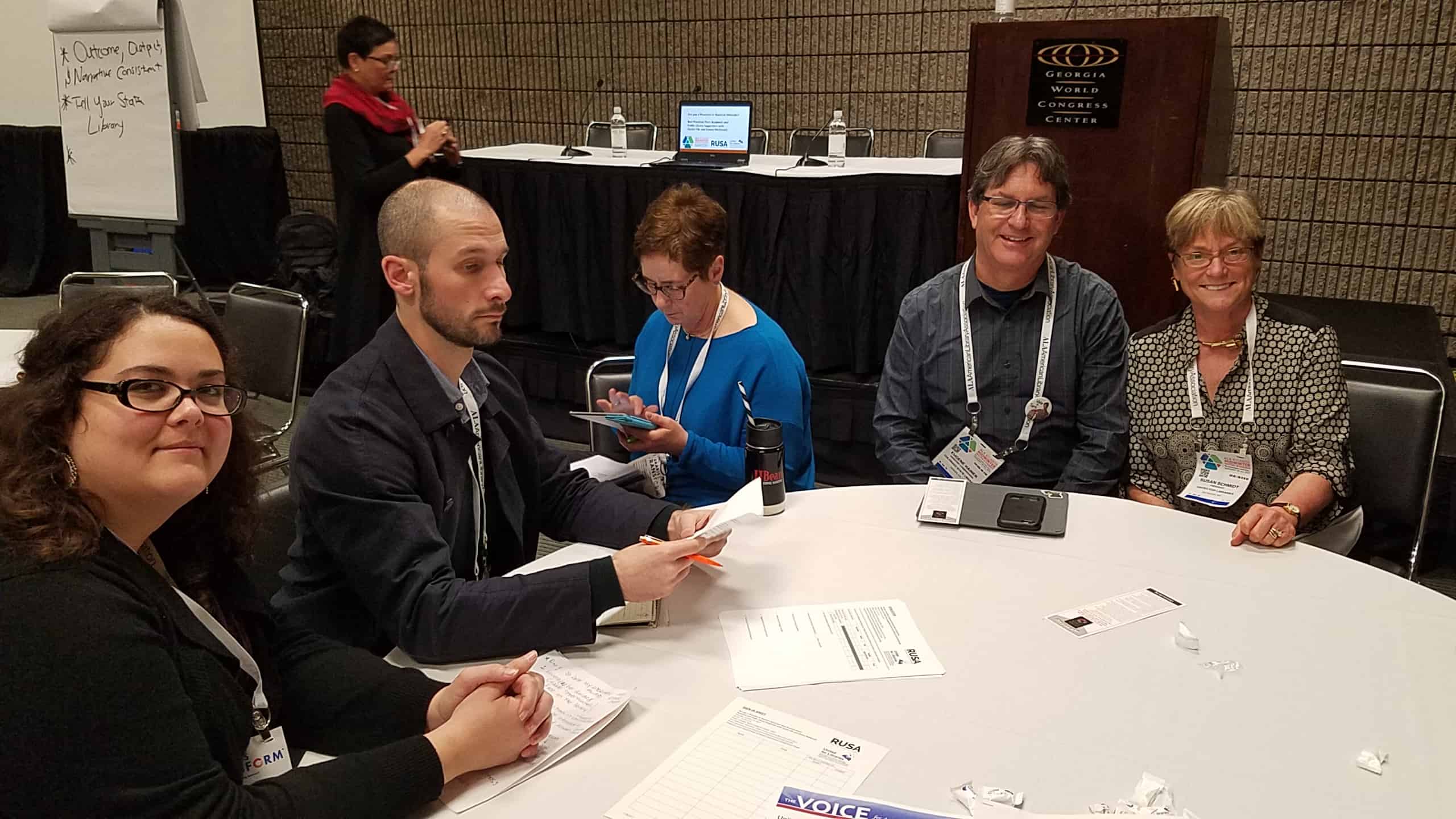 One of the breakout groups at the advocacy meeting. From left: Casey Wallace, Christopher Moffat, Elissa Checov (a 2016 I Love My Librarian winner), Eugene Hamer, and Susan J. Schmidt (United for Libraries president). In the background is Donna McDonald (United for Libraries secretary).