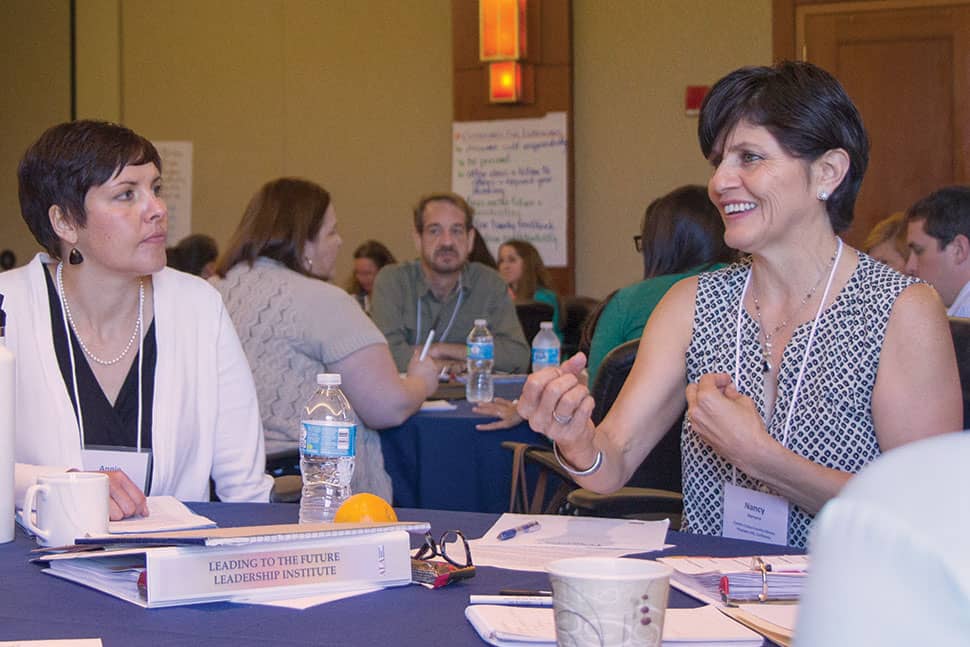 Annie Lewis (left), librarian at Multnomah County (Oreg.) Library, listens as Nancy Herrera, librarian at Contra Costa County (Calif.) Library, makes her presentation at the 2016 ALA Leadership Institute in Itasca, Illinois. The institute—developed and led by former ALA President Maureen Sullivan (2012–2013)—offers midcareer librarians the opportunity to take part in a four-day immersive leadership development program.