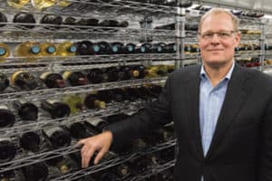 John Wilkinson stands in the John Wilkinson Family Wine Library at Cornell University in Ithaca, New York, which can store 3,400 bottles of wine. <span class="credit">Photo: Matt Hayes/College of Agriculture and Life Sciences</span>