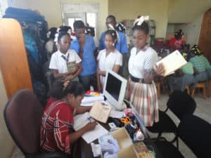 Students check out books in the Petit Goave Public Library in Haiti.