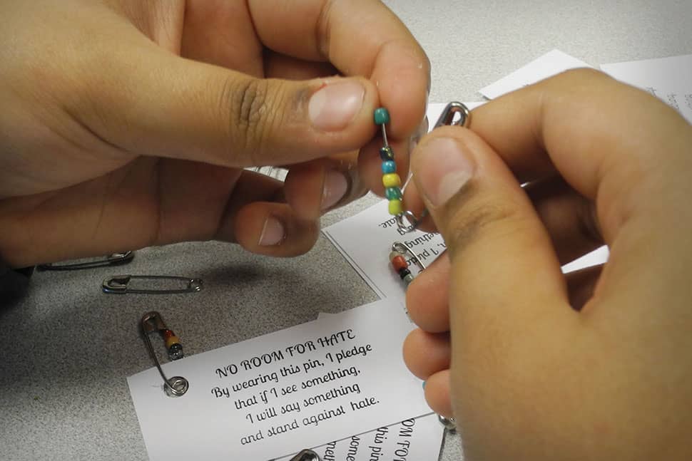 The library circulation desk at Oliver McCracken Middle School in Skokie, Illinois, offers “No Room for Hate” pins assembled by the Social Justice Club that demonstrate a wearer’s pledge to stand up against injustice.