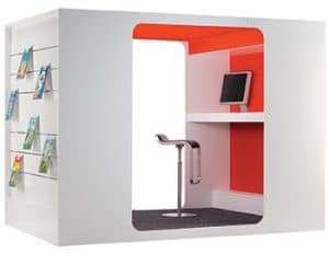 Image of the Cocoon Media Lounge, a box with slatwall attachments and a chair inside.