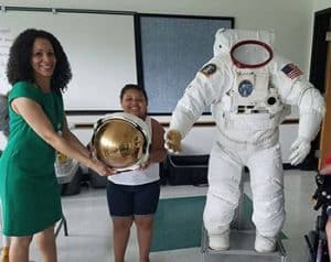 ILC Dover, a company that manufactures equipment for NASA, brought a real astronaut suit to the Garfield Park Lending Library in New Castle, Delaware, for NASA Day @ Your Library in July. <span class="credit">Photo: Yumarys Polanco-Miller</span>