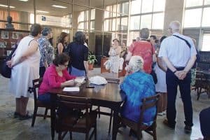 The ALA tour group listens as Nancy Coradin (center) translates the narrative about the Biblioteca Nacional de Cuba José Martí in Havana. Photo: Barbara Conaty.