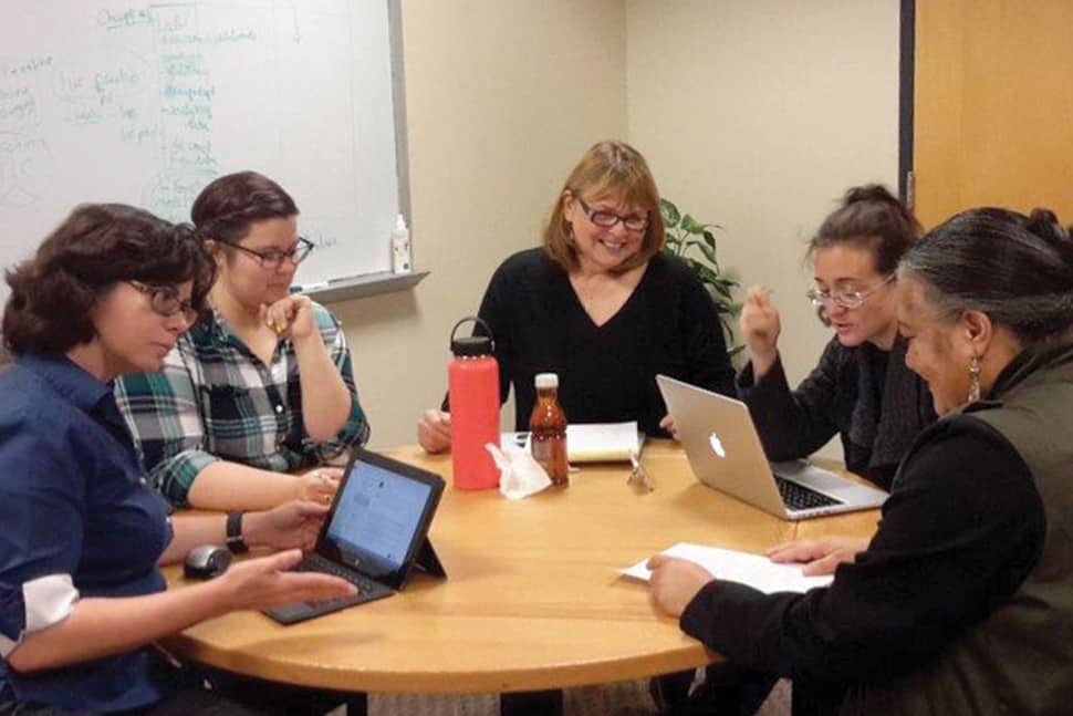 Denice Adkins (left) and Elizabeth Jean Brumfield (far right) at an LIS curriculum committee meeting at the University of Missouri in Columbia.