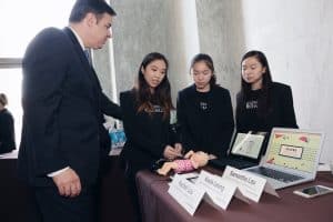 Rep. Raúl Labrador (R-Idaho) watches a demonstration of the SaveBB app from developers (from left) Kayla Leung, Rachel Lau, and Samantha Lau at the 2016 #HouseOfCode event cosponsored by ALA's Washington Office.