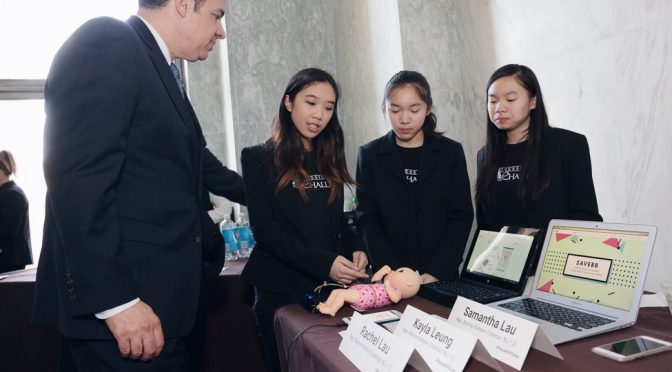 Rep. Raúl Labrador (R-Idaho) watches a demonstration of the SaveBB app from developers (from left) Kayla Leung, Rachel Lau, and Samantha Lau at the 2016 #HouseOfCode event cosponsored by ALA's Washington Office.