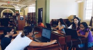 2016 Congressional App Challenge winner Kayla Leung (second from right) teaches coding at Perth Amboy (N.J.) Public Library. 