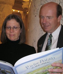 Idaho State Librarian Ann Joslin (left) first got to know Idaho State Representative Mike Moyle by sharing a children's book with him in the rotunda of the state capitol building. Moyle is now the Idaho House Majority Leader.