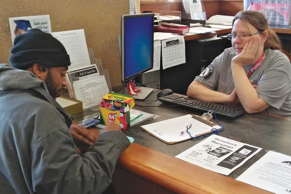 Dallas Public Library Youth Services Administrator Melissa Dease assists a homeless patron during the annual Winter Backpack Challenge, part of the library’s Homeless Engagement and Leadership program. Photo: Dallas Public Library