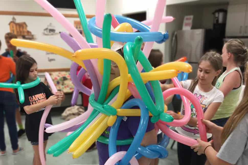 Tweens at Evergreen Community Library in Metamora, Ohio, covered librarian Debbie Henricks in balloons to celebrate a 2017 summer reading milestone. Photo: Courtesy of Evergreen Community Library