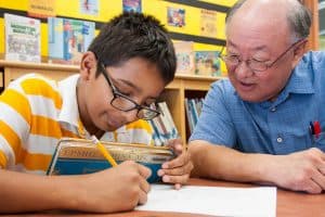 Gary Yamagiwa, a teacher with Chicago Public School’s Teacher in the Library program, works with a student at Chicago Public Library’s Austin-Irving branch. Photo: Chicago Public Library