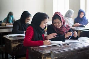 Students at a teacher’s college in Parwan Province, Afghanistan, learn about the Darakht-e Danesh Library.