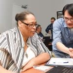 Staff members of Charlotte Mecklenburg (N.C.) Library assist seniors at a YMCA DigiLit class designed to help bridge the digital knowledge divide.Photo: Everett Blackmon