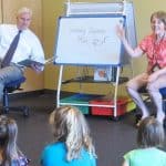 Rep. Tom Emmer (R-Minn., left) reads to a group of children at Great River Regional Library in St. Cloud with LuAnne Chandler, patron services associate. Photo: Abby Faulkner