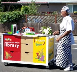 Chef Steve Cortez pushes Redwood City (Calif.) Public Library's mobile kitchen, La Cocina de Libros. <span class="credit">Photo: Redwood City Public Library</span>