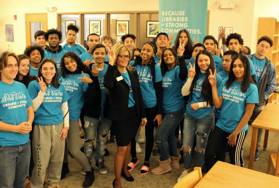 ALA President Loida Garcia-Febo (center) and students at Cranston (R.I.) High School East pose in the school's library.