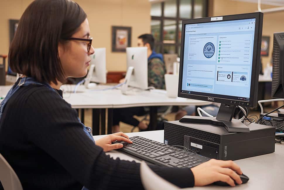 Penn State University student Luz Sanchez Tejada uses the school's microcredentialing platform in Pattee Library to earn badges as part of her peer research consultant training. Photo: Steve Tressler