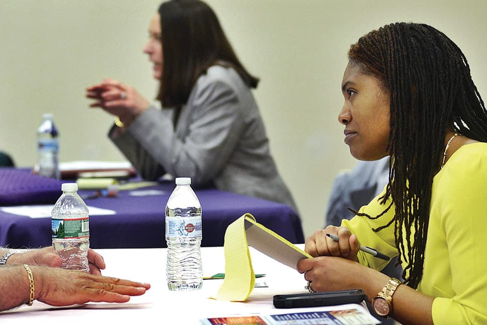 Roberta McCulloch-Dews, director of administrative services in Pittsfield, Massachusetts, listens during a speed-repping event at Berkshire Athenaeum.