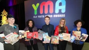 From left: YALSA President Crystle Martin, Coretta Scott King Chair Claudette McLinn, ALSC President Jamie Campbell Naidoo, ALA President Loida Garcia-Febo, and Reforma President Madeline Pena Feliz at the 2019 ALA Youth Media Awards presentation. <span class="credit">Photo: Cognotes</span>