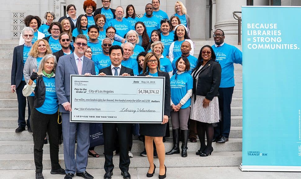 Los Angeles City Librarian John Szabo (front row, from left), Councilmember David Ryu, and ALA President Loida Garcia-Febo hold a giant check for nearly $4.8 million, symbolizing the efforts of the nearly 7,500 volunteers who contributed 164,000 hours of work in Los Angeles Public Library's 73 locations in 2018. Photo: Los Angeles Public Library