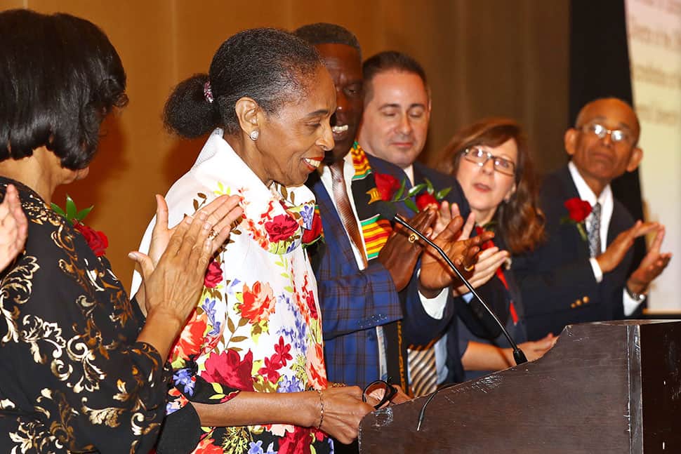 Pauletta Bracy (second from left) gets a standing ovation as she receives the Virginia Hamilton Award for Lifetime Achievement during the Coretta Scott King Book Awards 50th Anniversary Breakfast.