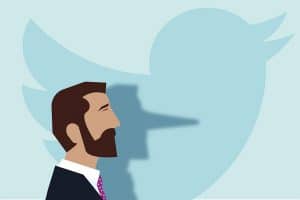 Man whose shadow nose extends Pinocchio-style in front of the Twitter bird logo