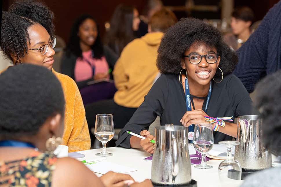 Sade Wilkins El (right), an intern with Public Library Association's Inclusive Internship Initiative (III), networks at the III wrap-up event in Washington, D.C.