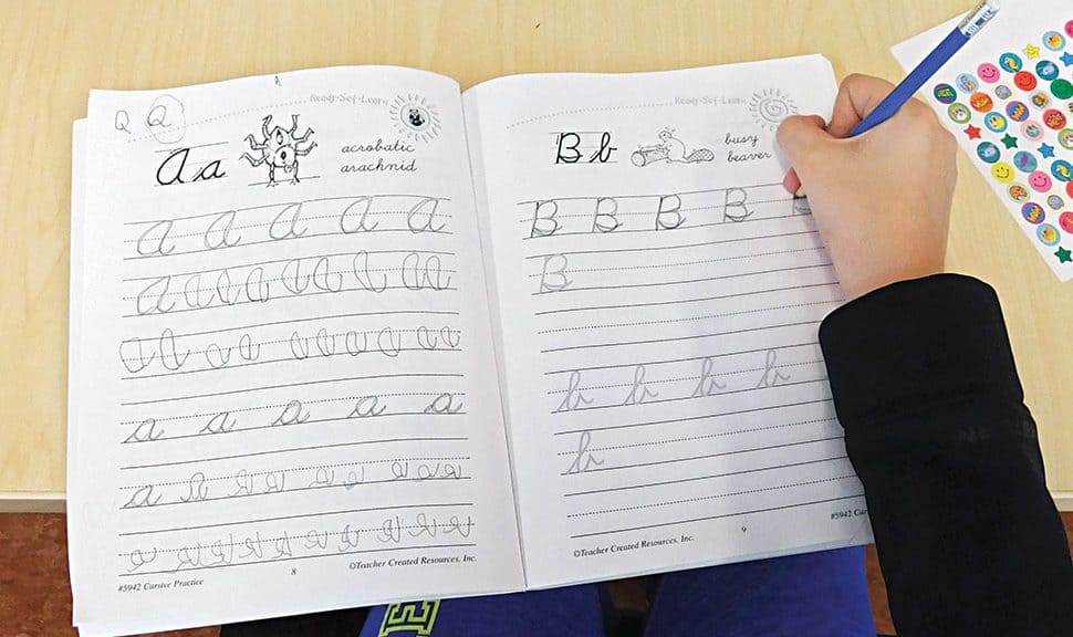 A participant in a cursive workshop at L. P. Fisher Public Library in Woodstock, New Brunswick, Canada, practices the alphabet. (Photo: Jenn Carson)