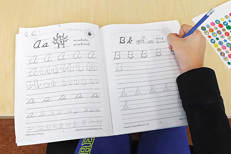 A participant in a cursive workshop at L. P. Fisher Public Library in Woodstock, New Brunswick, Canada, practices the alphabet. (Photo: Jenn Carson)