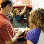 Nebraska City (Neb.) Mayor Bryan Bequette (left) and his wife and daughter celebrate after solving a puzzle in the Morton-James Public Library’s escape room.