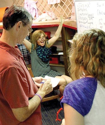 Nebraska City (Neb.) Mayor Bryan Bequette (left) and his wife and daughter celebrate after solving a puzzle in the Morton-James Public Library’s escape room.