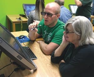 Teachers at Waubonsie Valley High School try out zSpace’s AR/VR laptops.