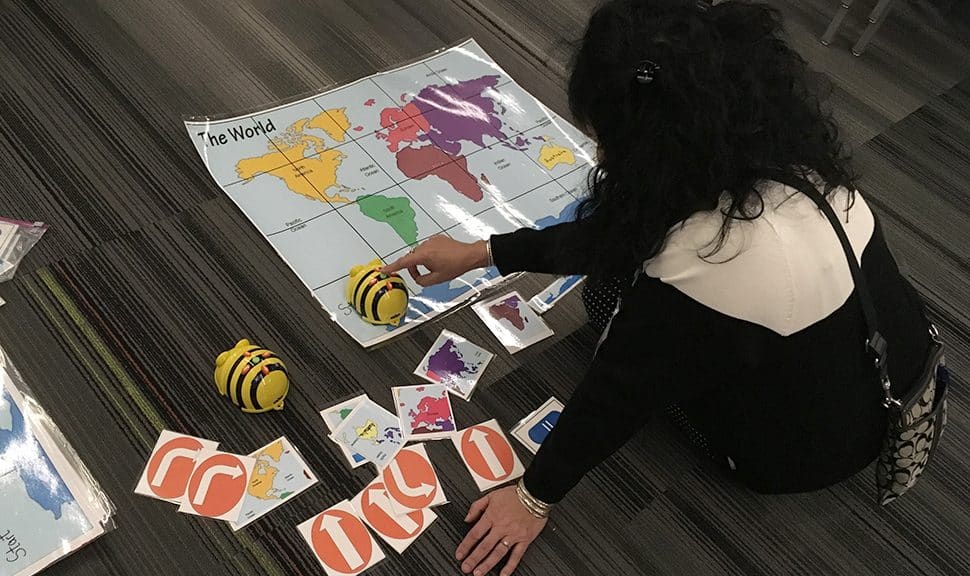 A librarian uses a Bee Bot at Do the Bot—Librarians Using Robots to Impact Learning at AASL 2019. Photo: Phil Morehart
