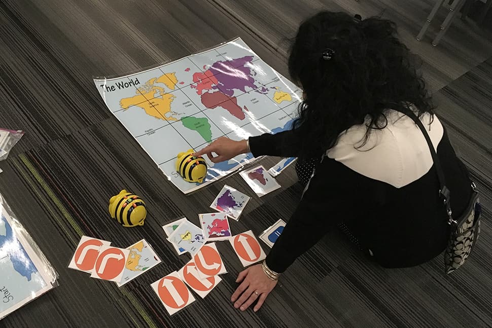 A librarian uses a Bee Bot at Do the Bot—Librarians Using Robots to Impact Learning at AASL 2019. Photo: Phil Morehart