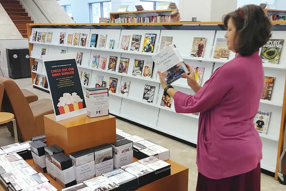 Leah Elzner, a staff member at Mandel Public Library in West Palm Beach, Florida, looks over the latest binge bundles. (Photo: Mandel Public Library in West Palm Beach, Florida)