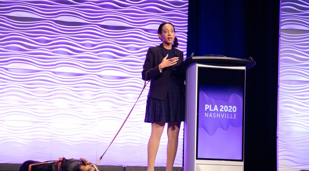 Disability rights advocate Haben Girma (and her guide dog Milo) on stage at the Public Library Association 2020 Conference in Nashville February 28. (Photo: Laura Kinser/Kinser Studios)