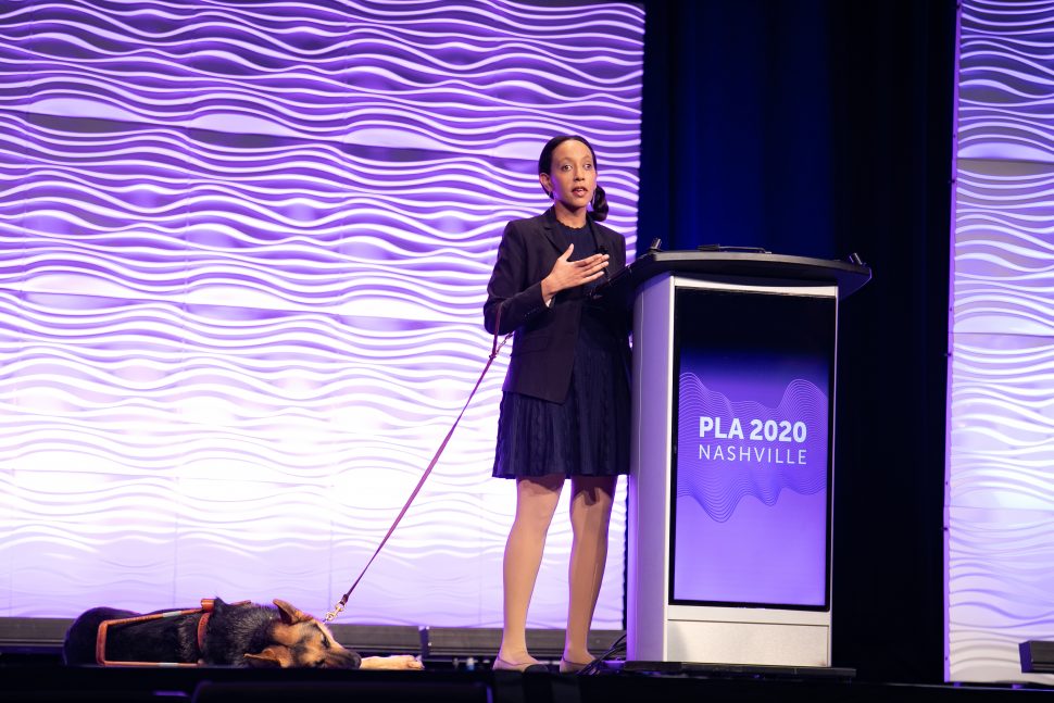 Disability rights advocate Haben Girma (and her guide dog Milo) on stage at the Public Library Association 2020 Conference in Nashville February 28. (Photo: Laura Kinser/Kinser Studios)