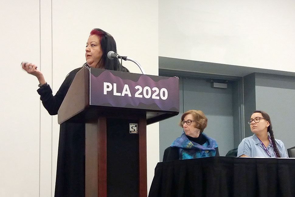 From left: Melanie Toledo (at podium), Carolyn Petersen, and Janessa Esquivel.