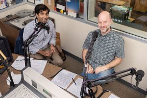 Ameet Doshi (left), director of innovation and program design and subject librarian at Georgia Tech’s (GT) School of Public Policy and Law, and Charlie Bennett, public engagement librarian and subject librarian for GT’s School of Economics, in GT’s campus radio station. (Photo: Allison Carter/Georgia Institute of Technology)