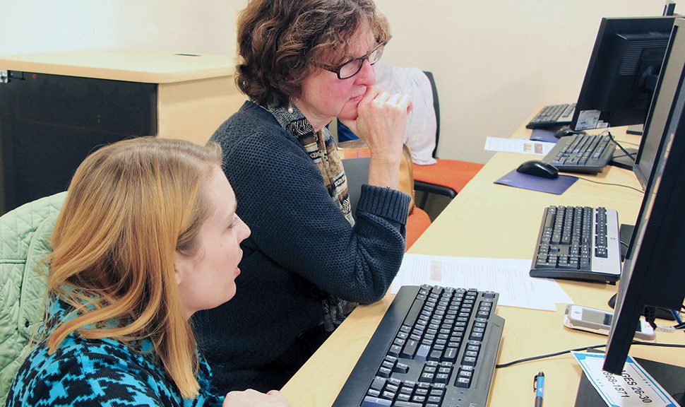 Law Librarians of New England members Ashley Selima (left) and Stephanie Edwards work with Rhode Island’s early suffrage documents at a 2018 transcription party. Photo: Joe Graziano/Rhode Island Department of State