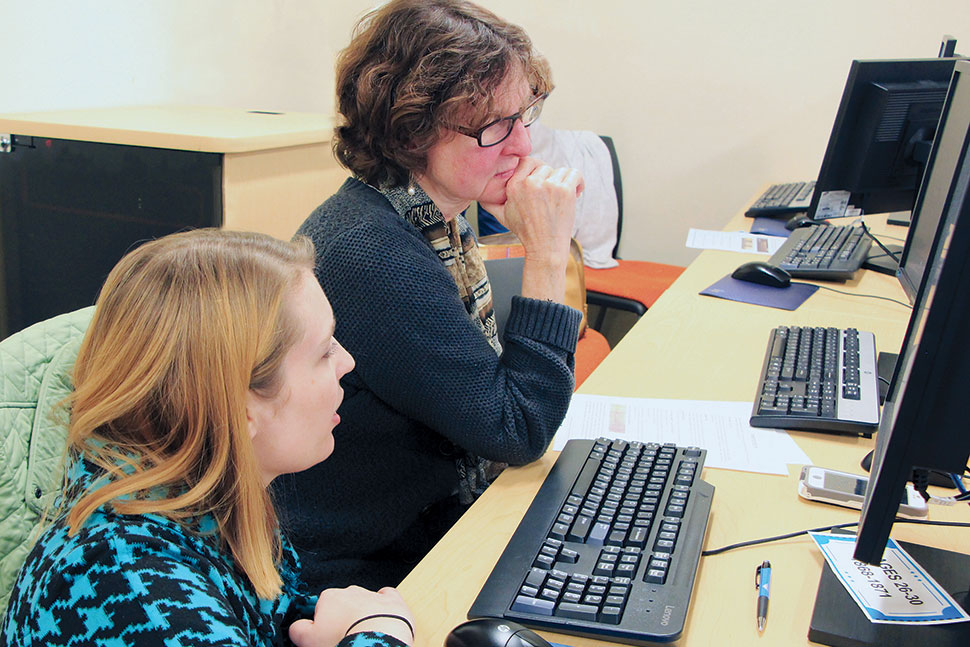 Law Librarians of New England members Ashley Selima (left) and Stephanie Edwards work with Rhode Island’s early suffrage documents at a 2018 transcription party. Photo: Joe Graziano/Rhode Island Department of State