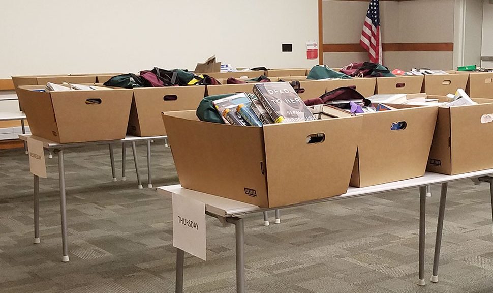 Boxes of returns organized by day in the large meeting room at Elmhurst (Ill.) Public Library. All items sit in quarantine for three days before small teams working in shifts check them in and reshelve them. Photo: Alea Perez/Elmhurst Public Library