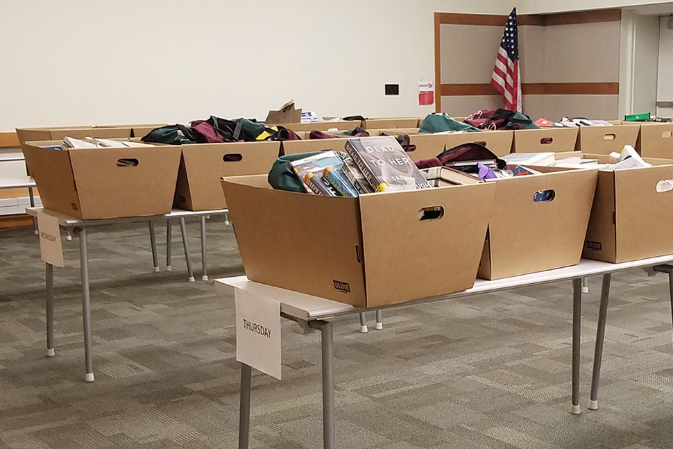 Boxes of returns organized by day in the large meeting room at Elmhurst (Ill.) Public Library. All items sit in quarantine for three days before small teams working in shifts check them in and reshelve them. Photo: Alea Perez/Elmhurst Public Library