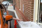 A customer picks up her reserves at the drive-through window at Columbus (Ohio) Metropolitan Library’s New Albany branch.