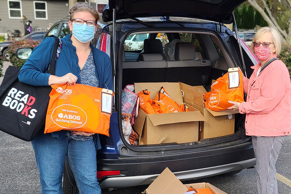 ABOS Treasurer Brooke Bahnsen (left) and ABOS Secretary Lori Berezovsky prep swag bags to mail to the first 250 registered attendees of the virtual conference.