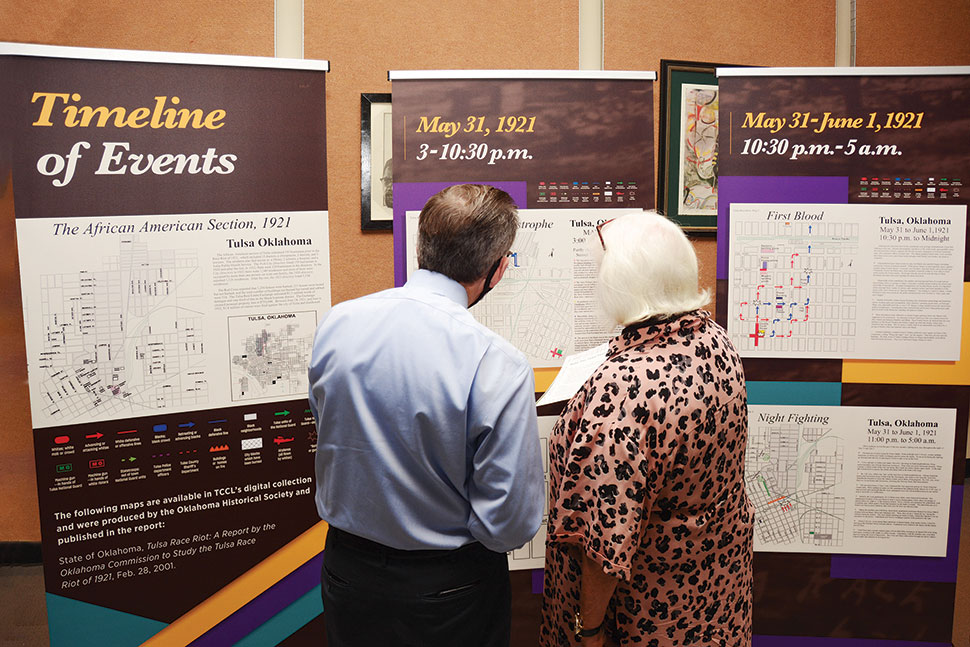 Photo of patrons at Tulsa (Okla.) City–County Library view an immersive exhibit on the 1921 Tulsa race massacre in spring 2021.