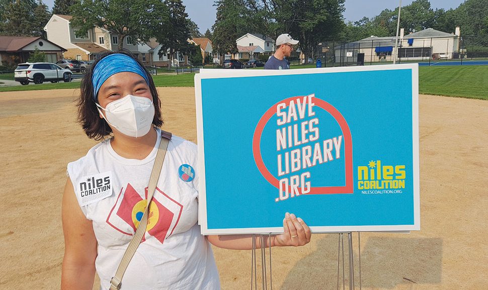 A protester at the Save Niles Library rally in July. Organizers met at a local park, then marched to the library for a public hearing on proposed budget cuts.